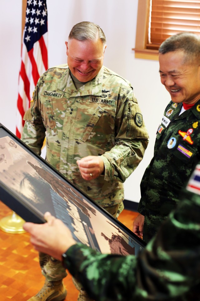 Gen. Narongpan Jittkaewtae, commander in chief, Royal Thai Army, and Maj. Gen. Bret Daugherty, the adjutant general, share a laugh at the Washington National Guard Museum at Camp Murray, Wash., on May 25, 2023. During the visit to Camp Murray,...