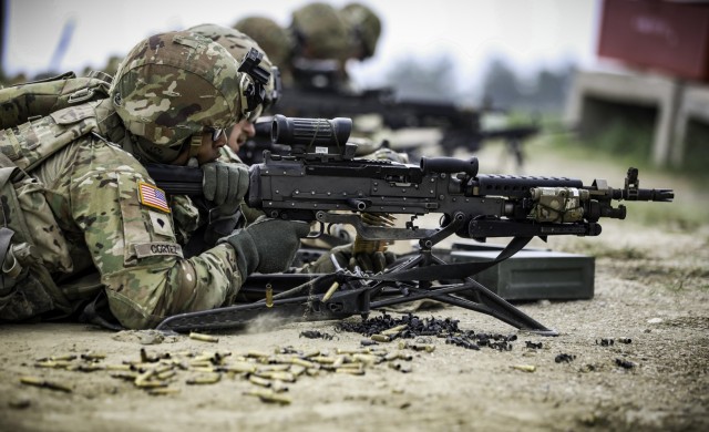 Spc. Chris Cortez, an infantryman assigned to Company C, 1st Battalion, 168th Infantry Regiment, 2nd Infantry Brigade Combat Team, 34th Infantry Division, fires an M240 machine gun during a squad live-fire at Camp Guernsey Joint Training Center in...