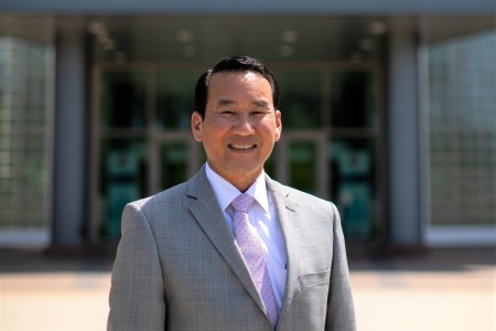 Myles M. Miyamasu, the Army Materiel Command Deputy G-3, stands in front of the AMC headquarters building at Redstone Arsenal, Alabama, April 28, 2022. (U.S. Army photo by Eben Boothby)