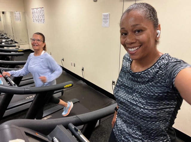 Aurora Cantarella, left, and De Neiya Goodly encourage each other at Nelson Fitness Center on Fort Gordon while participating in a friendly step competition .