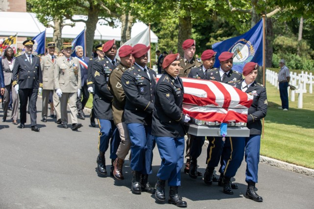 U.S. Army soldiers from the 173rd Airborne Brigade, carry a casket containing the remains of a WWI unknown soldier during his burial ceremony at Oise-Aisne American Cemetery for that soldier.