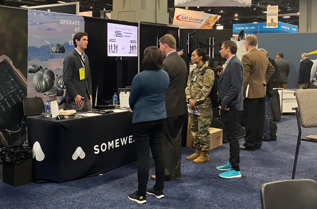 Mr. William Nelson, Deputy Assistant Secretary of the Army, Research and Technology, and Dr. Matt Willis, Director of Army Prize Competitions and the Army Applied SBIR Program, speak with industry members on the showroom of the AUSA annual meeting...