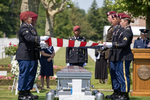 U.S. Army soldiers from the 173rd Airborne Brigade, fold an American flag over the casket containing the remains of a WWI unknown soldier during his burial ceremony at Oise-Aisne American Cemetery, France.