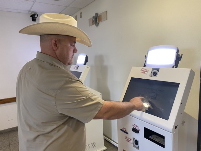 Edgar Ford, chief of the access control branch, Fort Cavazos Directorate of Emergency Services, uses a new self-service kiosk located in the Marvin Leath Visitors Welcome Center. The process is simple and only takes a few minutes. (U.S. Army photo...