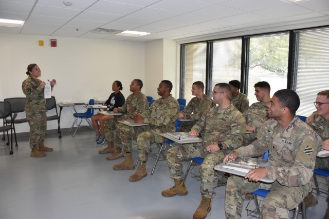 Staff Sgt. Leslie Martinez, Installation Reception Center, provides a briefing for new Soldiers Thursday at the IRC. (U.S. Army photo by Janecze Wright, Fort Cavazos Public Affairs)