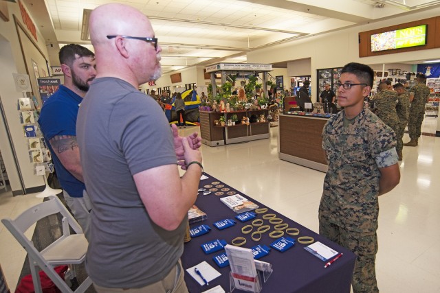 Marine Pfc. Aldo Cancinos speaks with Joshua Boley (center) and Travis Brown, with Ozarks Technical Community College’s Veterans Upward Bound program on Wednesday at the Main Exchange during an education fair, hosted by the Truman Education Center. The fair brought more than 20 colleges and universities to the post, providing a chance for service members, civilians, retirees and family members to learn more about higher education opportunities in the area. Veterans Upward Bound is a free college-prep program funded by the Department of Education, that is designed to help refresh academic skills for qualified veterans. 