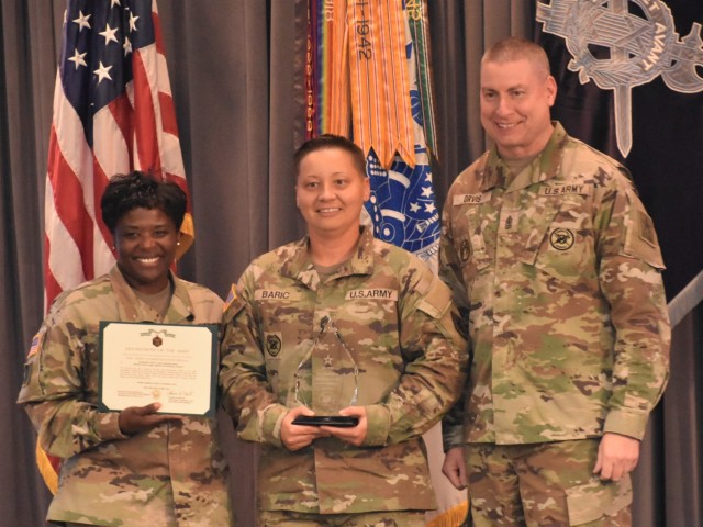U.S. Army Lt. Gen. Donna W. Martin, left, the Inspector General; Sgt. 1st Class Dariana Baric, center, the noncommissioned officer Inspector General of the Year; and Sgt. Maj. Larry Orvis, the Inspector General Sergeant Major, stand together after Baric was presented an Army Commendation Medal for her achievement. Baric and four other IGs were honored at the Worldwide Inspector General Conference at Camp Robinson, Arkansas, May 23, 2023. (U.S. Army photo by Thomas Ruyle)
