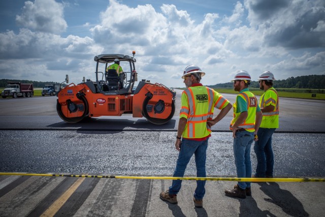 Matthew Hoyle (middle), U.S. Army Corps of Engineers materials engineer, oversees asphalt placement at Hunter Army Airfield, June 2. As a materials engineer, Hoyle reviews the methods, approach, quality of work, designs and asphalt mixtures to ensure proper asphalt density and USACE runway standardization requirements.