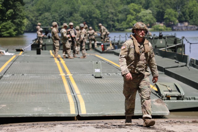 Army Staff Sgt. John Dennison, a platoon sergeant with the Kentucky National Guard’s 2061st Multi-Role Bridge Company, walks off the raft bridge onto the shore during the Homeland Defender Exercise at the Muscatatuck Training Center in Butlerville, Ind., June 9, 2023. Homeland Defender is a three-day, multi-agency exercise that brought together the Indiana National Guard, Kentucky National Guard, FEMA, Indiana first responders, and Verizon Communications.

