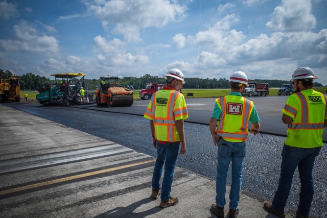 Matthew Hoyle (middle), U.S. Army Corps of Engineers materials engineer, oversees asphalt placement at Hunter Army Airfield, June 2. As a materials engineer, Hoyle reviews the methods, approach, quality of work, designs and asphalt mixtures to ensure proper asphalt density and USACE runway standardization requirements.