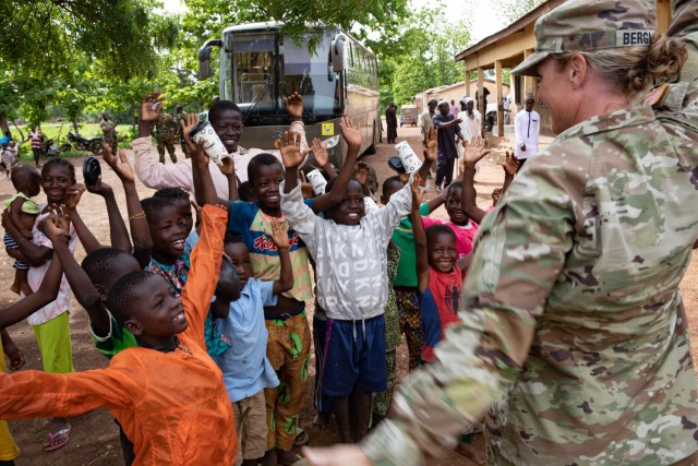 U.S. Army Lt. Col. Glenna Bergland, public health nurse, 352nd Civil Affairs Command, engages with local children during a medical event as part of exercise African Lion 2023 in Yendi, Ghana, June 3, 2023