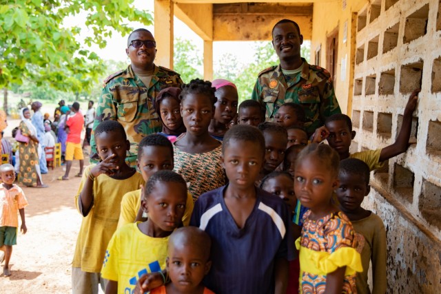 Ghana Army Soldiers pose for a photo with local children in Yendi, Ghana, June 3, 2023, during a medical civic action program as part of exercise African Lion 2023.