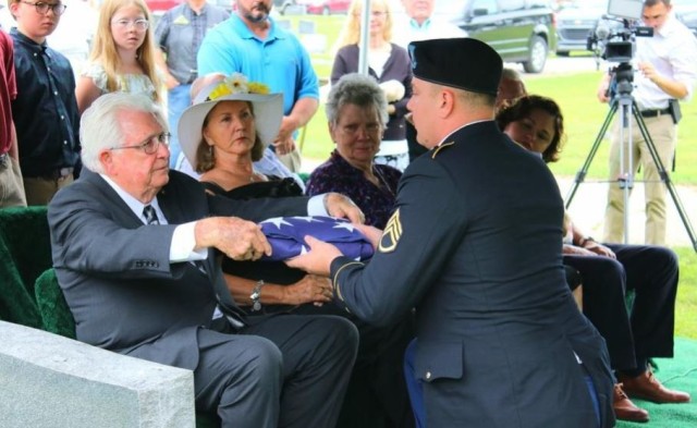Staff Sgt. Ohler presents U.S. Army Air Forces Staff Sgt. Ralph D. Kolb&#39;s American Flag to his nephew, Harold Kolb Jr. at his military funeral in McGehee, Arkansas.