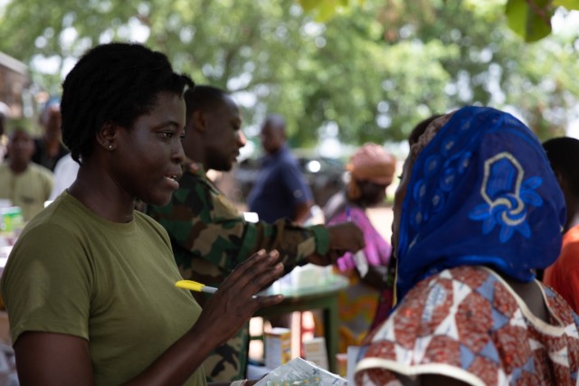 A healthcare provider from the Ghana Armed Forces gives medication instructions to a woman in Yendi, Ghana, June 3, 2023, during medical civic action program as part of exercise African Lion 2023.