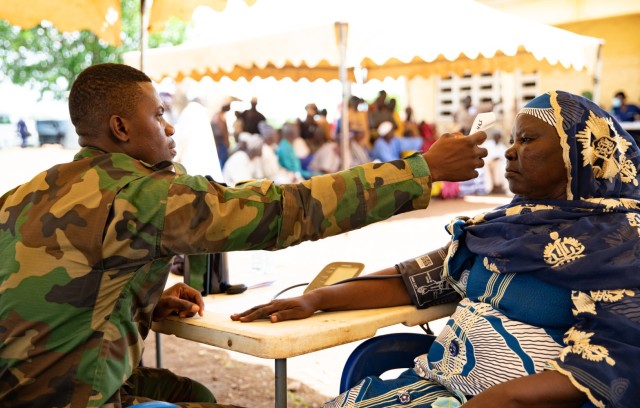 A medical technician with the Ghana Armed Forces checks vitals on a civilian during a medical civil action program in Yendi, Ghana, June 3, 2023, as a part of exercise African Lion 2023.