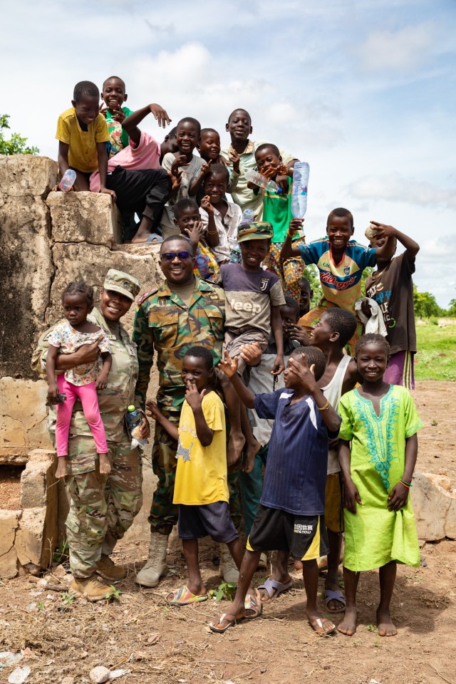 U.S. Army Master Sgt. Bisi Akindele, health care noncommissioned officer, 352nd Civil Affairs Command, engages with Ghana servicemembers and children during a medical civic action program in Yendi, Ghana, June 3, 2023, as part of exercise African Lion 2023.