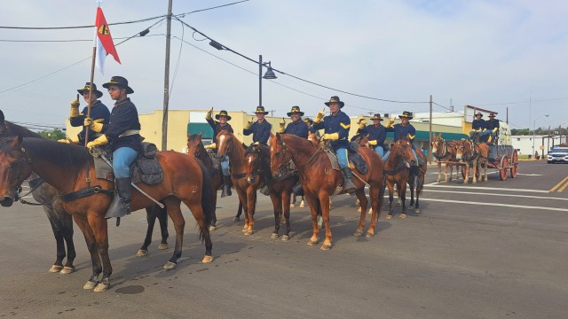 Twelve 1st Cavalry Division Horse Cavalry Detachment Soldiers, dressed in traditional uniforms and carrying the detachment guidon, traveled on 10 horses, followed by a wagon pulled by two mules during the annual Juneteenth Celebration Parade June 17 in downtown Killeen. (U.S. Army photo by Janecze Wright, Fort Cavazos Public Affairs) 