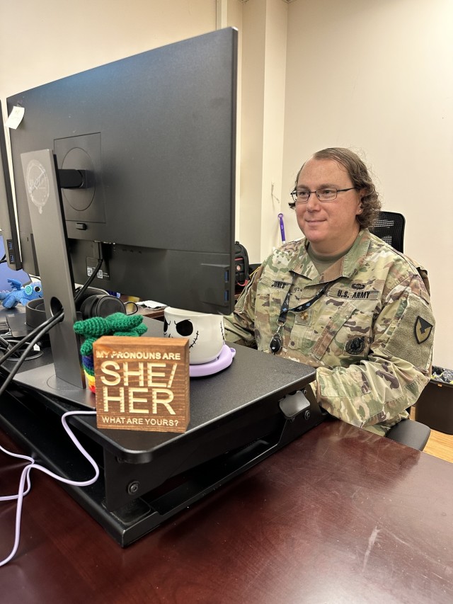 Maj. Rachel Jones, U.S. Army Sustainment Command’s Cyber Division chief, G6 (Information Management), serves openly as a transgender female Soldier. Featured on her desk is a wood sign stating “My pronouns are she/her. What are yours?”