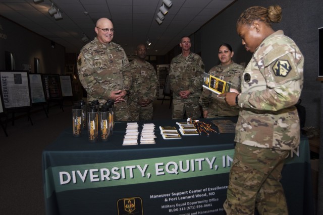 Army equal opportunity experts provide information to visitors at the Army Heritage Month open house at the John B. Mahaffey Museum Complex on June 15. 