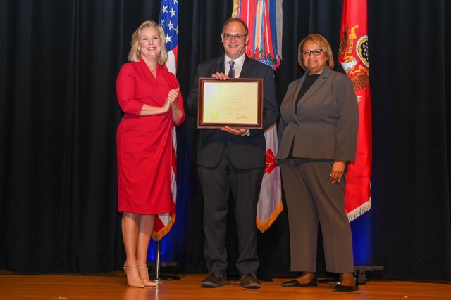 Dr. Donald Carlucci receives a Meritorious Senior Professional Award from Army Secretary Hon. Christine E. Wormuth.
