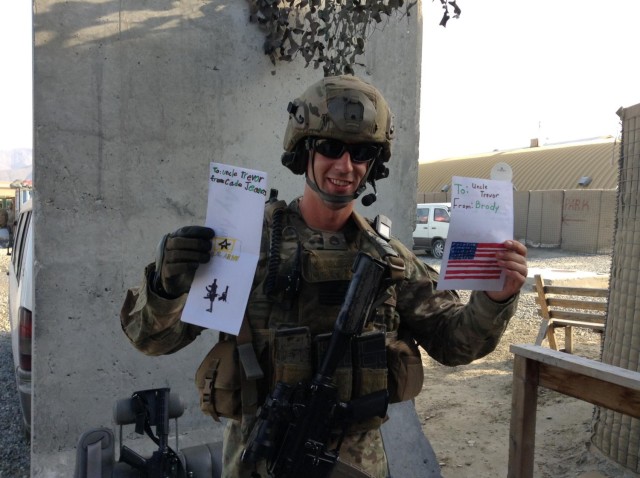 Sgt. 1st Class Ean Eicher, displaying heartfelt greetings courtesy of his nephews during a 2012 deployment to Afghanistan.


