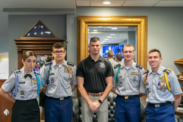 Army JROTC Cadets pose with a member of the Old Guard after receiving tour of the facilities where the Tomb Guard Sentinels prepare on June 20 at Arlington National Cemetery in Washington D.C. Four JROTC Cadets competing in the Army JROTC...