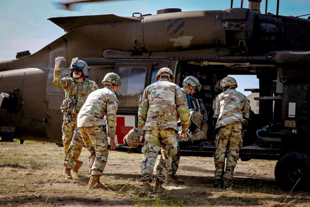 Soldiers assigned to 129th Area Support Medical Company and Forward Support MEDEVAC Platoon, 3rd Combat Aviation Brigade, 3rd Infantry Division conduct patient movement operations for aeromedical evacuation during a training while attending Saber Guardian 23 in Slobozia, Romania, June 1, 2023. Saber Guardian 23, a component of DEFENDER 23, is an exercise co-led by Romanian Land Forces and the U.S. Army at various locations in Romania to improve the integration of multinational combat forces by engaging in different events such as vehicle road marches, medical training exercises, and river crossings.