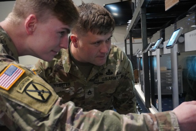                                SSG Webster, Additive Manufacturing Lead, instructs a 10th Mountain student on how to calibrate 3D printers. 