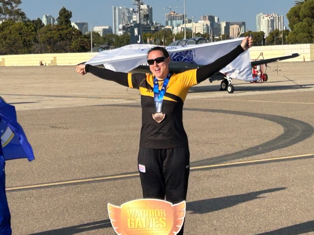 Maj. Tori Camire celebrates after winning gold in cycling during the DOD Warrior Games Challenge at Naval Air Station North Island, California.