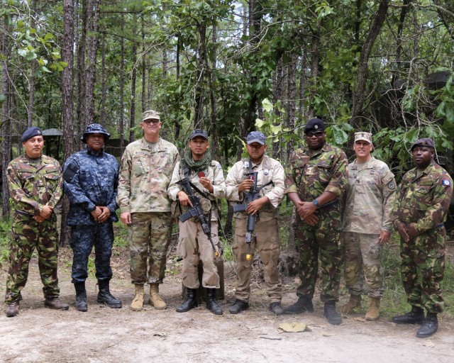 Maj. Gen. Keith Waddell, Louisiana National Guard adjutant general, and Command Sgt. Maj. Clifford J. Ockman Jr., Louisiana National Guard senior enlisted advisor, with service members from Belize during a visit to the Joint Readiness Training...