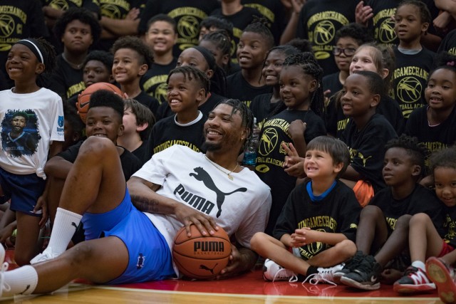 Marcus Smart, point guard with the Memphis Grizzlies, poses with the Macus Smark Basketball Clinic participants after the clinic had concluded June 24, 2023, at Abrams Physical Fitness More. More than 200 children participated in the clinic on Fort Cavazos. (U.S. Army photo by Blair Dupre, Fort Cavazos Public Affairs)