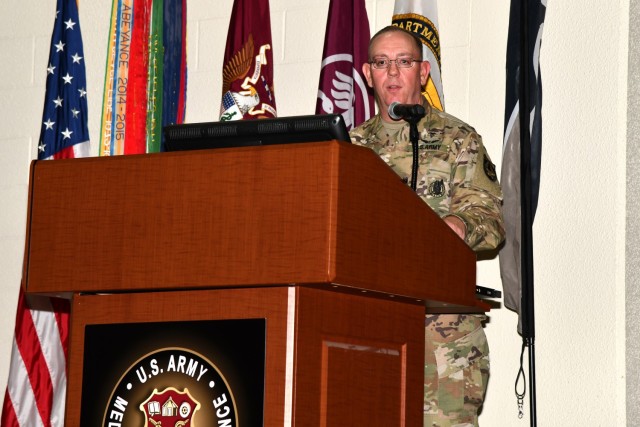 Col. James Jones accepts the 1st Quarter, Fiscal Year 2023 Army Medicine Wolf Pack Award for Project Convergence 22 - Medical, U.S. Army Medical Center of Excellence (MEDCoE), on June 27 in San Antonio, Texas.