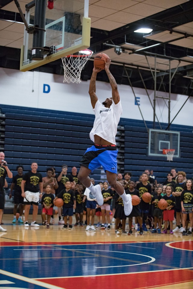 Marcus Smart attempts to dunk at the request of the children during the Marcus Smart Basketball Clinic June 24, 2023, on Fort Cavazos. &#34;We care about (the children),&#34; Smart said. &#34;We care about their families. We&#39;re thankful for what their families are doing for our country.&#34;  (U.S. Army photo by Blair Dupre, Fort Cavazos Public Affairs)