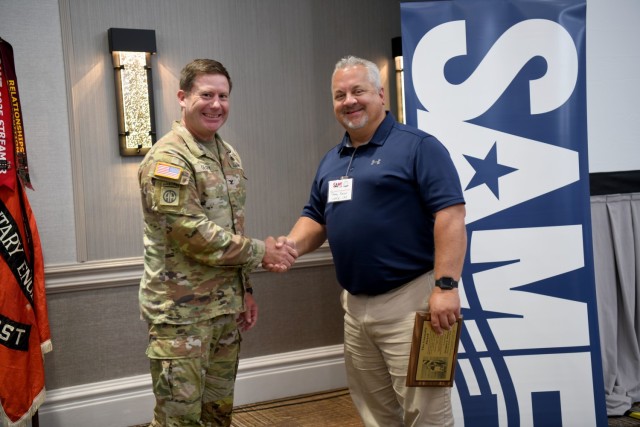 Douglas Saxon, deputy chief of Construction Division for the U.S. Army Corps of Engineers, Savannah District, is congratulated by Savannah Commander Col. Joseph Geary following an awards ceremony, June 27, where Saxon was honored with the 2023 James B. Connolly Award during the Society of American Military Engineers Annual Program Review. The award is presented annually to a civilian or military engineer for notable contributions in the field of engineering.