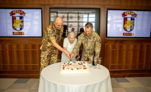 U.S. Army Maj. Gen. Todd R. Wasmund, commander of U.S. Army Southern European Task Force, Africa (SETAF-AF), right, Ms. Paola Del Din, center, and Italian army Maj. Gen. Ugo Cillo, Deputy Commander Operative Nord, cut the cake at Caserma Del Din...