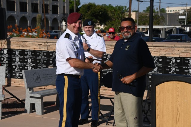 U.S. Army Yuma Proving Ground (YPG) NCO of the Year Sgt. 1st Class Justin Devaul (left) is recognized by Mark Martinez (right), commander of VFW Post 1763, at the Caballeros de Yuma’s 37th annual Fourth of July Flag Raising Ceremony at...