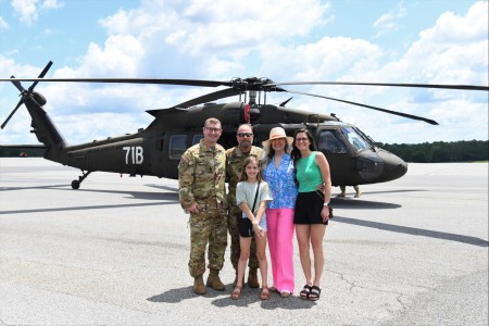 Rodney L. “Sande” Sangsland is joined by his wife Gladysa, daughter Rachael, granddaughter Lucy, and son-in-law Lt. Col. Nolan D. Roggenkamp, after taking his final flight in a Black Hawk helicopter at Fort Novosel’s Lowe Army Heliport June 20, 2023.