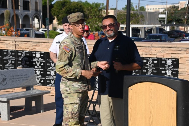 U.S. Army Yuma Proving Ground (YPG) Soldier of the Pvt. 1st Class Mekhii McTerry (left) is recognized by Mark Martinez (right), Commander of VFW Post 1763, at the Caballeros de Yuma’s 37th annual Fourth of July Flag Raising Ceremony at...