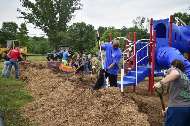 June 26, 2023 -- Fort Meade community members pitch-in spreading mulch to restore KABOOM playground.