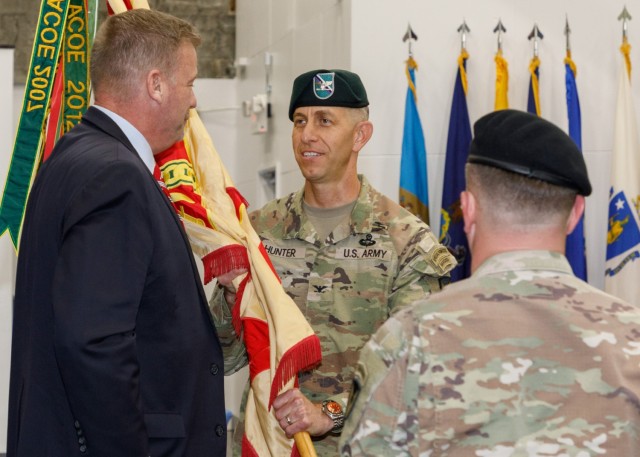 Col. Marcus S. Hunter, center, receives the colors of U.S. Army Garrison Japan from Craig Deatrick, director of U.S. Army Installation Management Command-Pacific, during a change-of-command ceremony at Camp Zama, Japan, July 7, 2023.