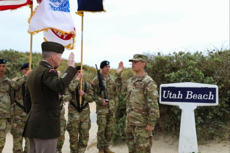 Maj. Gen. David Hodne, former commanding general of the 4th Infantry Division, give the Oath of Enlistment to Spc. Nathaniel Hills, a Manchester Township, New Jersey, native and cavalry scout assigned to the 4th Squadron, 10th U.S. Cavalry Regiment, 3rd Armored Brigade Combat Team, 4th Inf. Div., at Utah Beach, France, June 6, 2023. With the new terms of service, Hills is switching occupations within the Army to become a 68W Combat Medic. (U.S. Army photo by Sgt. Clara Harty)