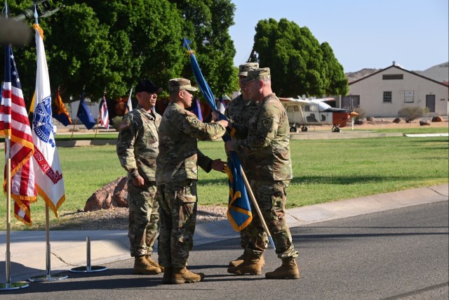 Command Sgt. Maj. Mark Millare (left) assumed responsibility as the highest-ranking enlisted Soldier at U.S. Army Yuma Proving Ground from post commander Col. John Nelson (right), as Master Sgt. Donald Bullock of the Airborne Test Force (left...
