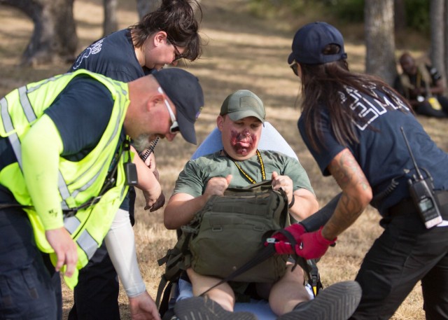 A role player, after being evaluated by Fort Cavazos EMS and loaded onto a stretcher, is evacuated out the simulated danger zone during the full-scale exercise July 11 at Fort Cavazos. (U.S. Army photo by Scott Darling, Fort Cavazos Public Affairs)