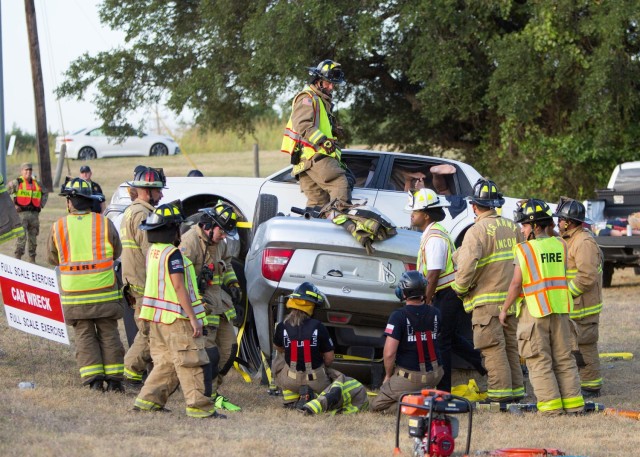 Department of Emergency Services and various agencies from neighboring Central Texas communities begin working on a simulated two-vehicle accident, which sparks a fire near a housing community on the installation July 11. (U.S. Army photo by Scott Darling, Fort Cavazos Public Affairs)