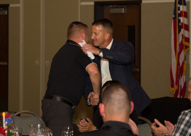 Col. Chad R. Foster, the now-former Fort Cavazos Garrison commander, embraces retired Col. Todd Fox, commissioner for the Texas Military Preparedness Commission, after his speech at the community leader dinner July 6. (U.S. Army photo by Scott Darling, Fort Cavazos Public Affairs)