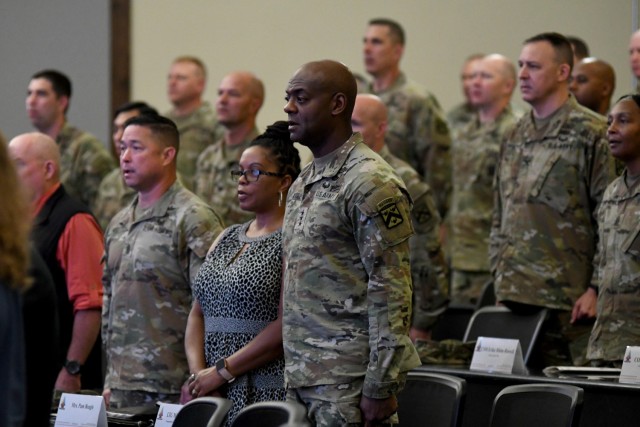 Combined Arms Center Command Sgt. Maj. Stephen Helton, Pam Beagle and CAC and Fort Leavenworth Commanding General Lt. Gen. Milford Beagle Jr. stand for the singing of the Army Song during the Mission Command Training Program Change of Command ceremony July 14, 2023 at McHugh Training Center, Fort Leavenworth, Kan. The ceremony for outgoing MCTP commander, Col. Bryan Babich, and incoming commander, Col. Richard Ikena, was officiated by Combined Arms Center-Training Deputy Commander, Col. Scott Woodward. Babich took responsibility for the Mission Command Center of Excellence in June and Ikena’s previous assignment was as the 1st Infantry Division Artillery Commander, Fort Riley, Kan. Photo by Tisha Swart-Entwistle, Combined Arms Center-Training Public Affairs.