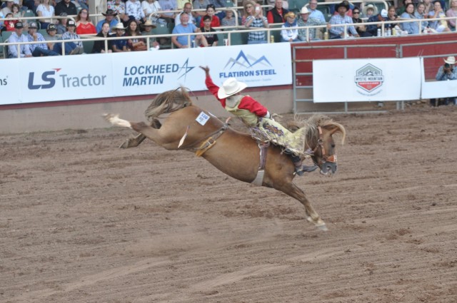 A bareback riding competitor rounds a barrel during the National Finals Rodeo Open at the Pikes Peak or Bust Rodeo Fort Carson and 4th Infantry Division Night, July 12 at the Norris-Penrose Event Center, Colorado Springs. Bareback riding is one of...