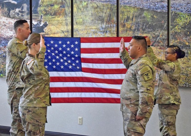 Capt. Autumn Mitchell, Company A commander, 35th Engineer Battalion (left), administers the Oath of Enlistment to Staff Sgt. Randell Adarme, one of her former drill sergeants, on June 30, at Cox Medical Center South, in Springfield, Missouri – where Adarme had a coronary artery bypass graft procedure in 2022, that potentially saved his life. 