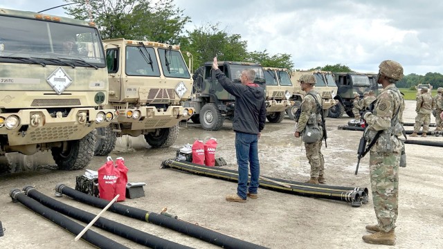 Defense Logistics Agency Energy Americas East Quality Assurance Representative Rob Rush (black jacket) works with U.S. Army Reservists to conduct inspections of military fuel tankers and equipment at Camp Atterbury, Indiana, during the U.S. Army Reserve’s 2023 Quartermaster Liquid Logistics Exercise June 12, 2023.