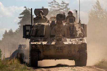 Soldiers drive a M109A6 Paladin self-propelled howitzer during a live-fire qualification exercise at Pabrade Training Area, Lithuania, July 12, 2023. The exercise is designed to assess the crew&#39;s proficiency and readiness.